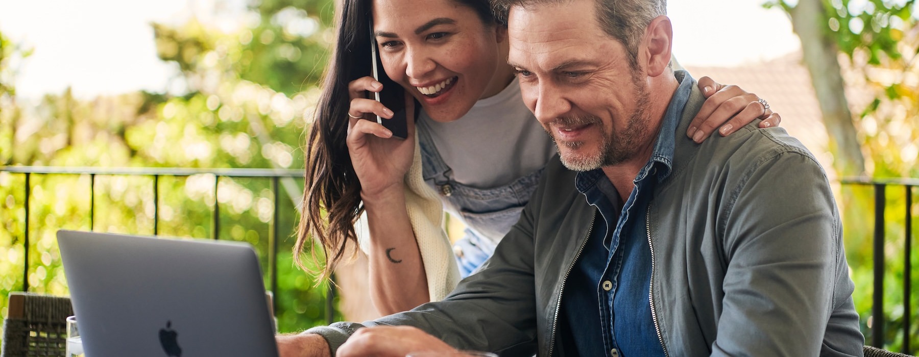 a man and a woman looking at a laptop